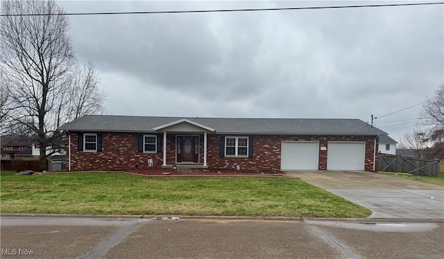 single story home featuring a front yard and a garage