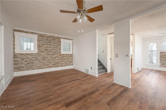 spare room featuring a textured ceiling, dark hardwood / wood-style floors, and ceiling fan