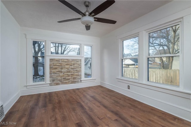 empty room featuring ceiling fan and dark hardwood / wood-style floors