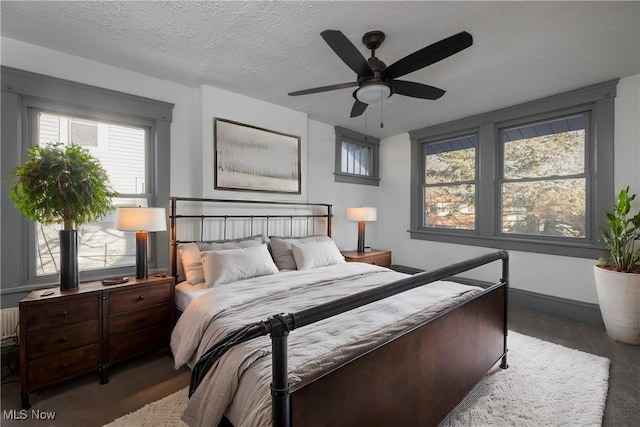 bedroom with a textured ceiling and ceiling fan