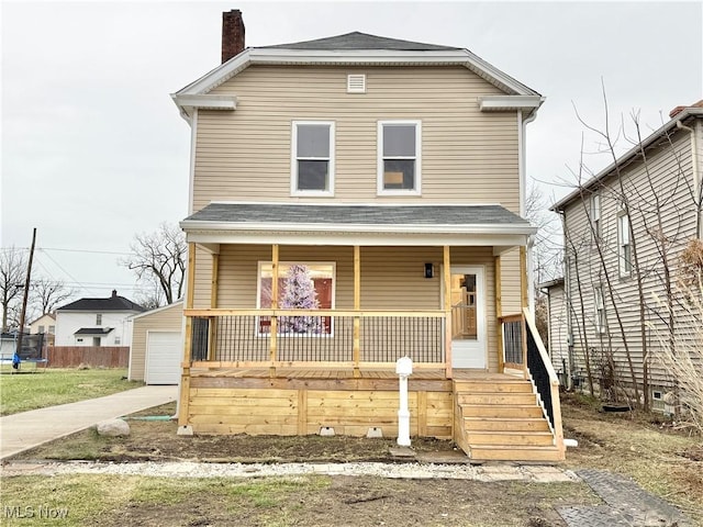 view of front property with a porch, an outbuilding, and a garage