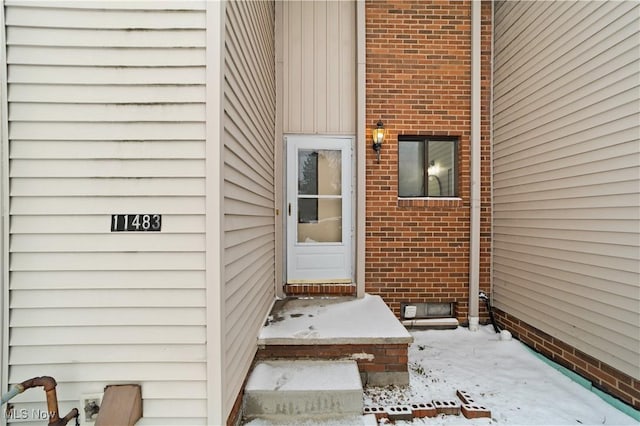 view of snow covered property entrance