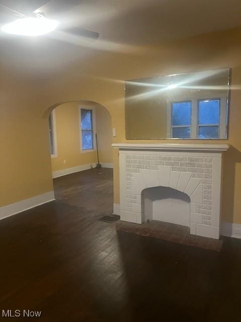 unfurnished living room with dark hardwood / wood-style flooring and a fireplace