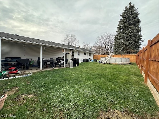 view of yard featuring a fenced in pool and a patio