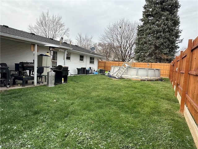 view of yard with a fenced in pool