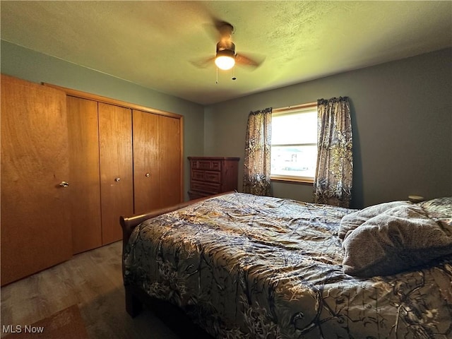 bedroom featuring hardwood / wood-style flooring, ceiling fan, and a closet