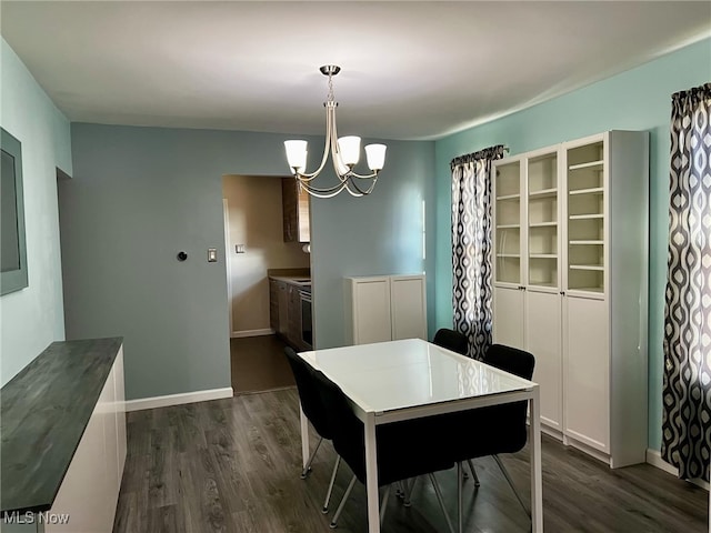 dining area featuring a chandelier and dark hardwood / wood-style flooring