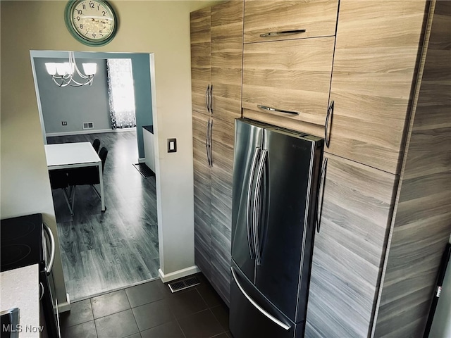 bathroom featuring tile patterned floors and a chandelier