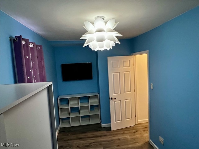 unfurnished bedroom featuring dark hardwood / wood-style flooring