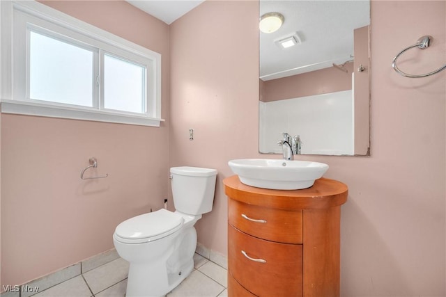 bathroom with tile patterned flooring, toilet, vanity, and baseboards