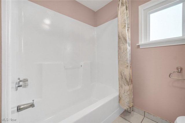 full bath with tile patterned flooring, shower / tub combo, and baseboards