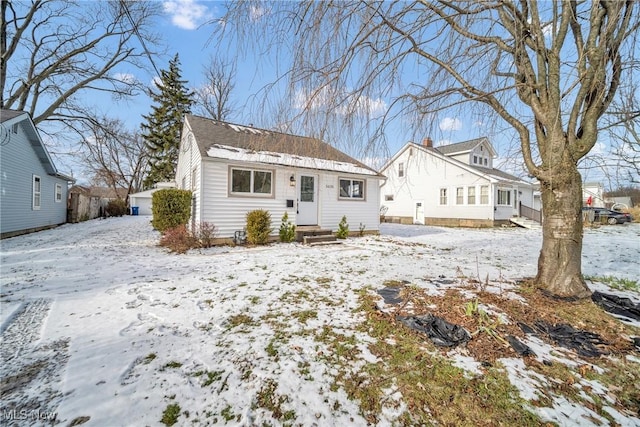 view of snow covered rear of property