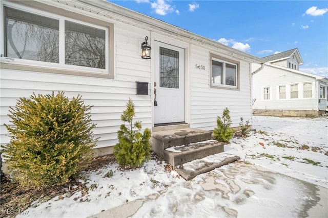 view of snow covered property entrance