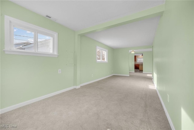 carpeted empty room featuring baseboards