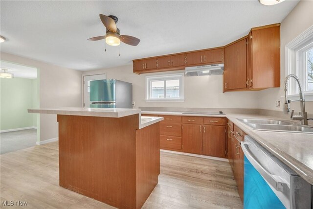 kitchen featuring dishwasher, sink, ceiling fan, stainless steel fridge, and light wood-type flooring