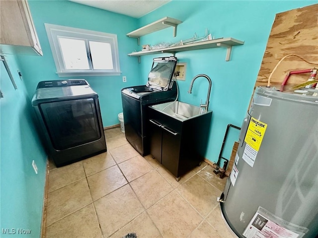 laundry area featuring light tile patterned floors, washing machine and clothes dryer, cabinet space, a sink, and electric water heater