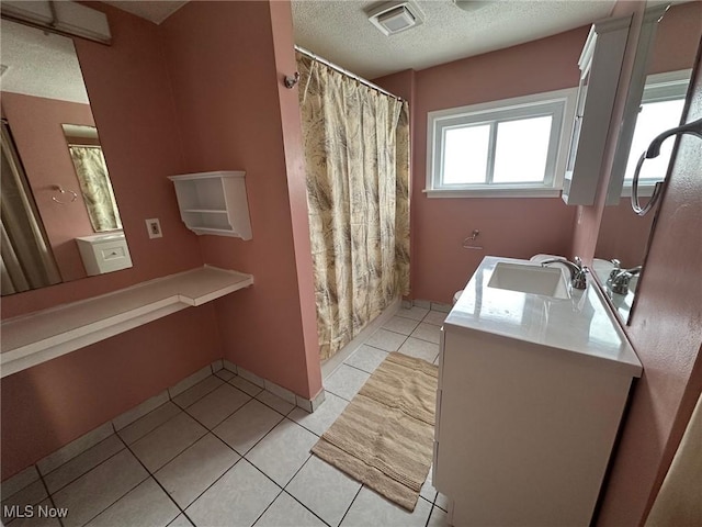 full bath with tile patterned floors, visible vents, a shower with curtain, a textured ceiling, and vanity