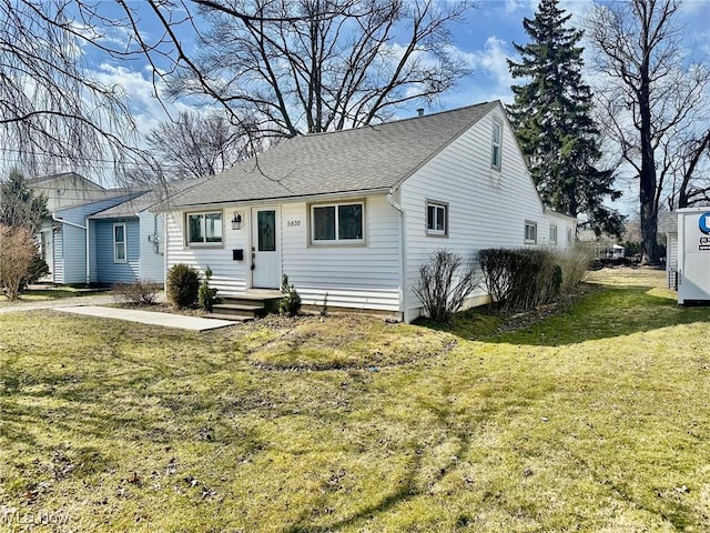 single story home with a front yard and roof with shingles