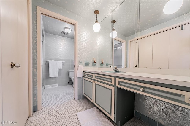 bathroom featuring vanity, tile patterned flooring, a shower stall, a textured ceiling, and toilet