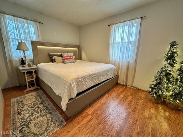 bedroom with hardwood / wood-style floors