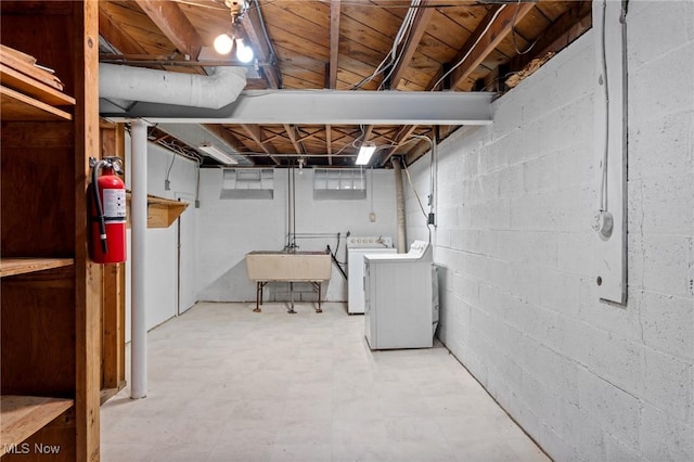 basement with washer and clothes dryer and sink