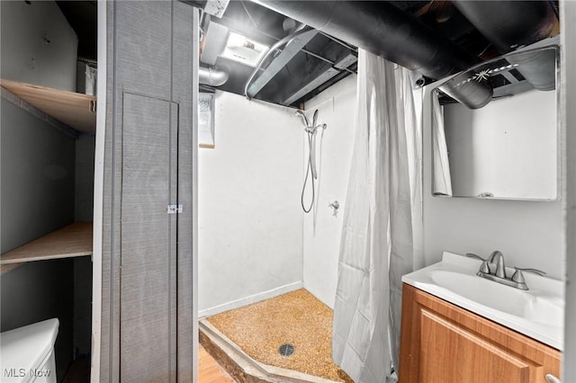 bathroom featuring vanity, curtained shower, and toilet