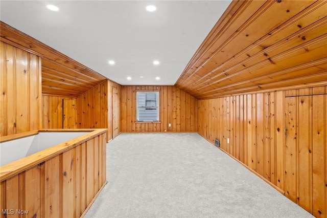 additional living space with light colored carpet, vaulted ceiling, and wood ceiling