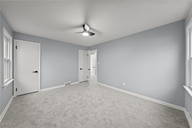 unfurnished bedroom with ceiling fan and light carpet