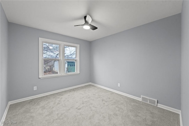 carpeted empty room featuring ceiling fan