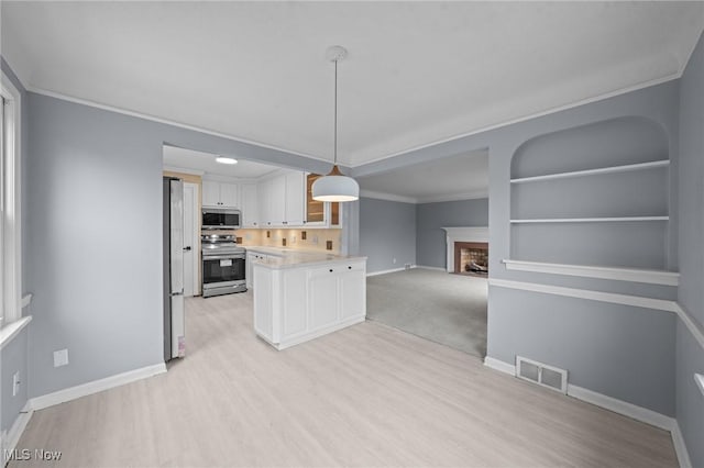 kitchen with white cabinets, hanging light fixtures, decorative backsplash, built in features, and stainless steel appliances