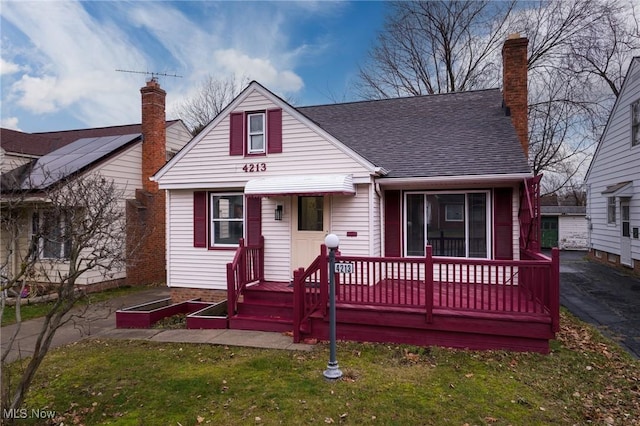 bungalow-style home with a front yard