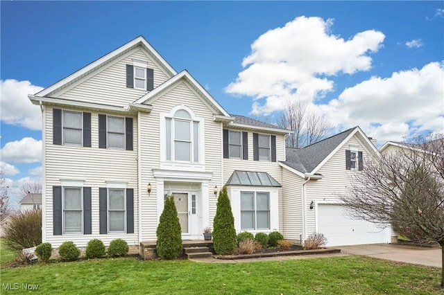 front of property featuring a garage and a front lawn