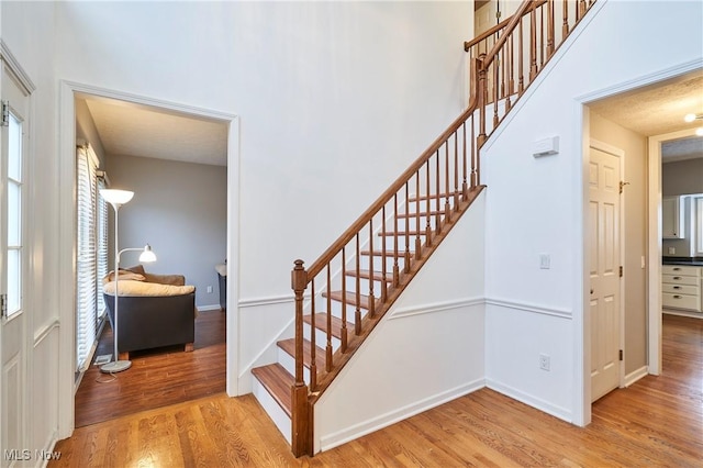 stairway with hardwood / wood-style flooring