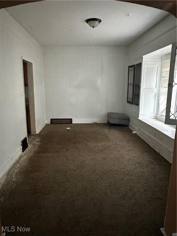 empty room with dark carpet