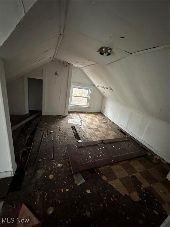 additional living space featuring lofted ceiling