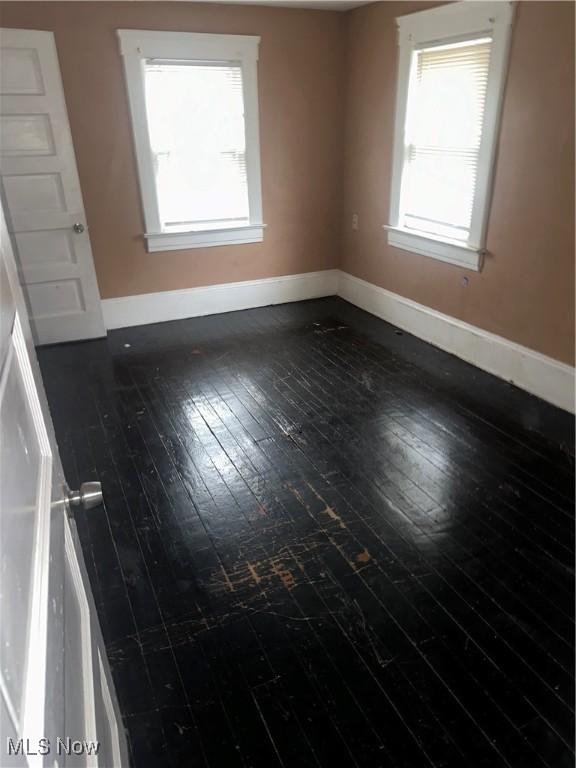 spare room featuring dark hardwood / wood-style floors