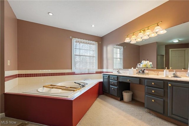 bathroom with vanity and a bath