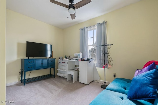 carpeted living room featuring ceiling fan