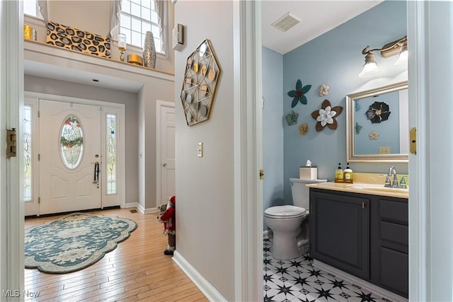 foyer featuring sink and light wood-type flooring