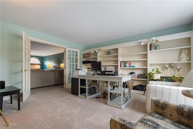 carpeted home office with french doors