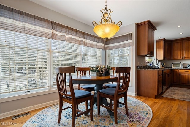 dining area with light wood-type flooring