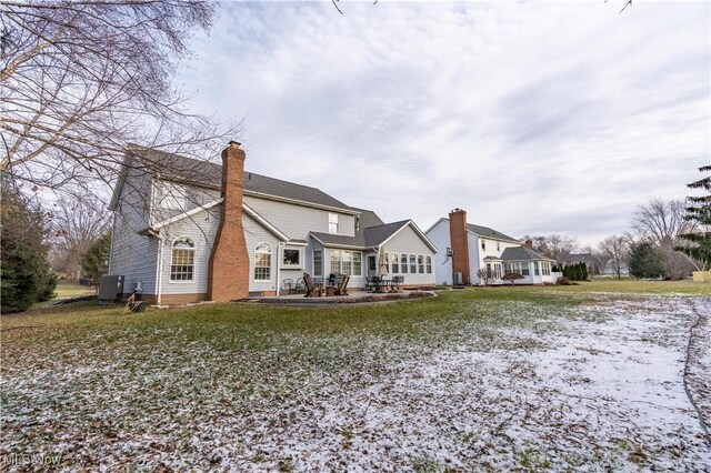 rear view of house featuring cooling unit, a patio area, and a yard