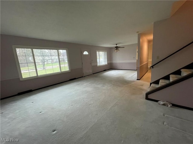 unfurnished living room with ceiling fan and light colored carpet