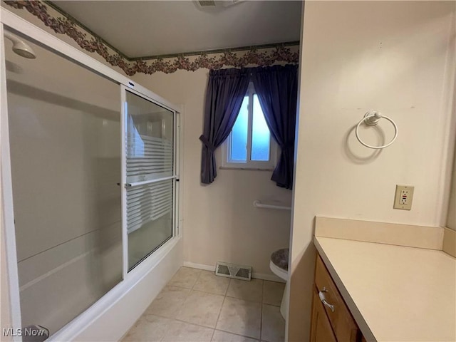 full bathroom with tile patterned floors, vanity, toilet, and shower / bath combination with glass door