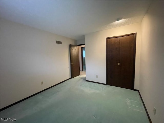 unfurnished bedroom with light colored carpet