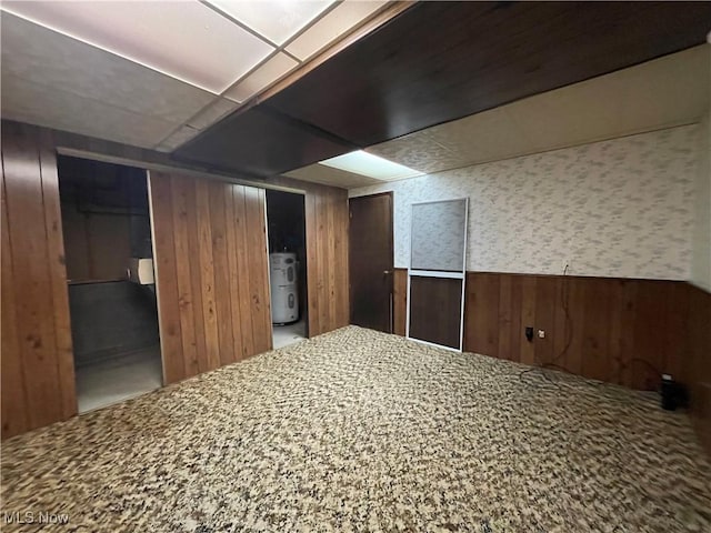 basement featuring wooden walls