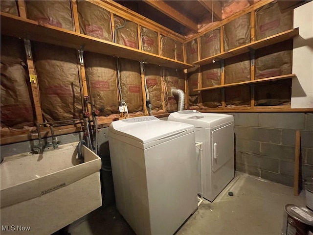 washroom with separate washer and dryer and sink