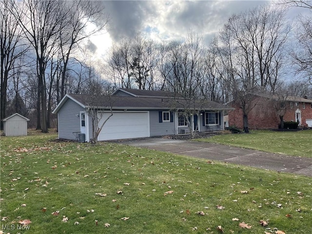 single story home featuring cooling unit, a front yard, and a garage