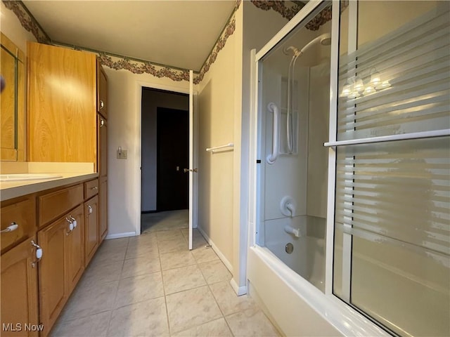 bathroom with vanity, tile patterned floors, and bath / shower combo with glass door