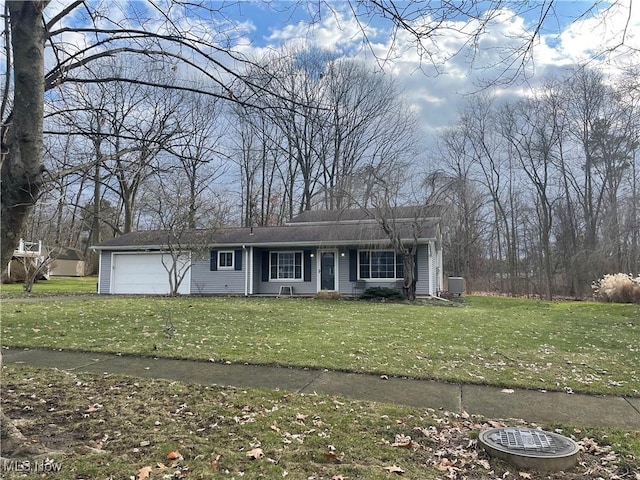 single story home featuring a garage and a front lawn